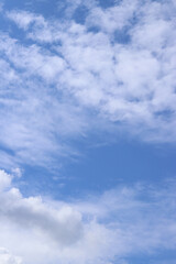 White clouds against the blue sky. Sky background. Summer. Landscape. Soft white clouds against the blue sky. Calm and serene atmosphere. White fluffy clouds