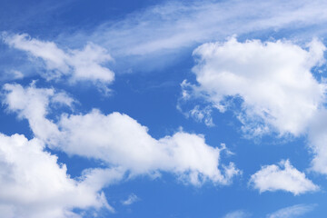 White clouds against the blue sky. Sky background. Summer. Landscape. Soft white clouds against the blue sky. Calm and serene atmosphere. White fluffy clouds