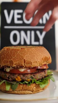 Placing a Delicious Vegan Burger on a Plate with a Vegan