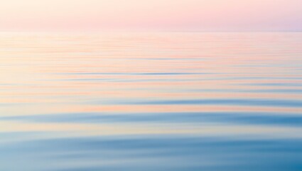Serene pastel sunrise reflects on calm ocean water creating a tranquil and dreamy seascape perfect for relaxation and design projects.