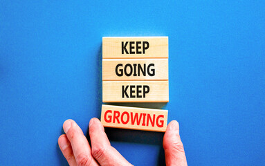 Keep going and growing symbol. Concept words phrase Keep going keep growing on beautiful wooden...