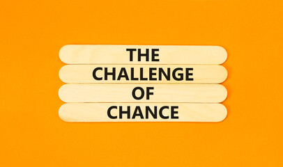 The challenge of chance symbol. Concept words phrase The challenge of chance on beautiful wooden stick. Beautiful orange paper background. Business The challenge of chance concept. Copy space.