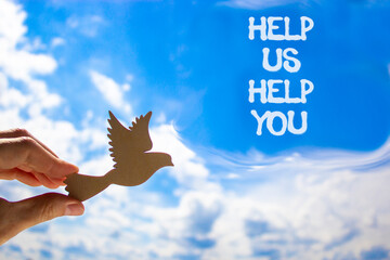 Help you symbol. Concept words phrase Help us help you on beautiful blue sky. Businessman's hand....