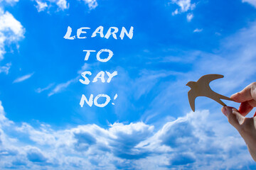 Learn to say no symbol. Concept words phrase Learn to say no on beautiful blue sky. Businessman's...