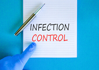 Infection control symbol. Concept words Infection control on beautiful white note. Doctor's hand in blue medical glove. Beautiful blue background. Medical healthy lifestyle infection control concept.