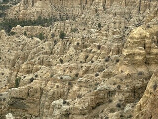 Rugged desert terrain with rock formations and distant mountains