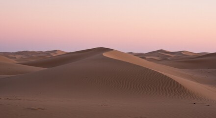 Fototapeta premium Desert Dunes at Dusk: A serene panoramic view unveils rolling sand dunes under a pastel sunset sky, creating a captivating display of natural beauty and tranquility.