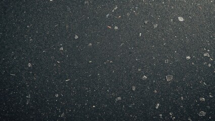 dark colored recycled plastic with visible specks of colorful fragments