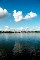 Panoramic view of left bank of the Dnieper River. Dnieper. Ukraine. Reflection of the sky with clouds on water surface.
