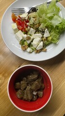 Well-balanced breakfast featuring healthy source of ptotein, fermented and fresh vegetables, salad and nuts on a plate. Top view real kitchen photo, diet and self care and love concept