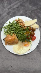 Well-balanced breakfast featuring healthy source of ptotein, fermented and fresh vegetables, salad and nuts on a plate. Top view real kitchen photo, diet and self care and love concept