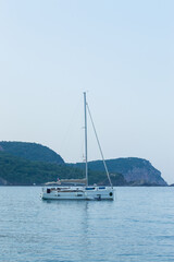 Yachting on a serene seascape at sea. A lone ship sailing on the water on a sunny summer day. Frontal view
