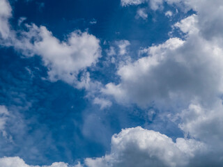 Expansive Blue Sky Adorned with Fluffy White Clouds