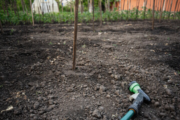 Gardening equipment and prepared soil plot for agricultural tasks in a rural area