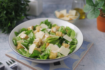 A bowl with classic Caesar salad	