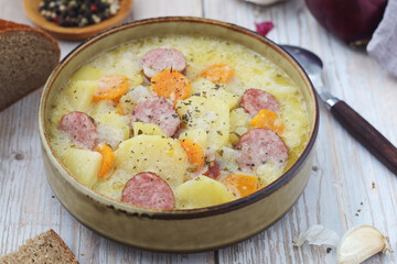 A bowl with traditional German potato soup with sausages	