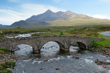 Sligchan Old Bridge with the peaks of Sgùrr nan Gillean, Am Basteir and Sgurr a Bhasteir, part of...