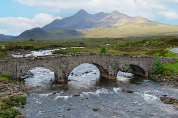 Sligchan Old Bridge with the peaks of Sg˘rr nan Gillean, Am Basteir and Sgurr a Bhasteir, part of...