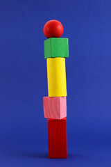 Geometric wooden figures placed one on top of the other