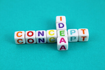 Colorful letter cubes join the words IDEA and CONCEPT