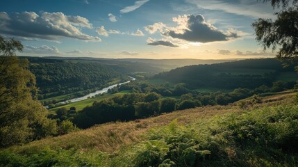 Naklejka premium Stunning sunset view over a lush green valley with a winding river and dramatic clouds in the sky.