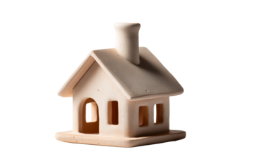 A small, decorative ceramic house model features a chimney and windows
