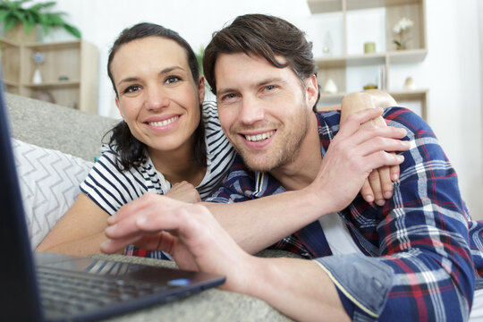 couple discussing home finances with paper and laptop