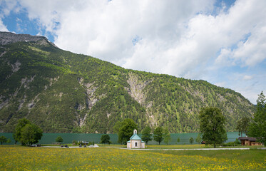 meadow with dandelions, small chapel, lakeside Achensee tyrol