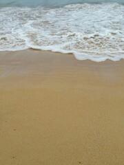 Gentle Waves of the Andaman Sea Washing Over Sandy Beach in Phuket, Thailand