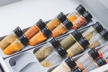 Organized Spice Drawer with Various Herbs and Seasonings