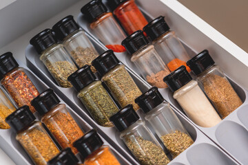 Organized Spice Drawer with Various Herbs and Seasonings