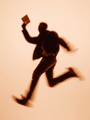 Excited Player Silhouette Jumping With Winning Slip in Vibrant Motion on a Warm Background