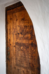 Carved wooden door with nautical motifs in a fishing village on the Mediterranean Sea