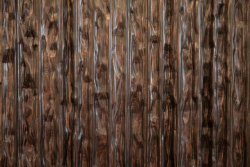 Dark carved wood panel with deep ripple pattern