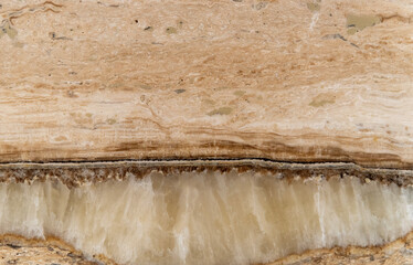 Natural layered travertine stone texture in warm beige tones