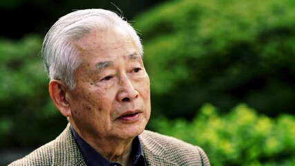 Thoughtful elder man portrait outdoors against natural foliage backdrop - Powered by Adobe