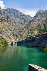 A captivating view of Kotor Old Town, Montenegro, nestled at the base of towering mountains. The historic walls and domed rooftops showcase the town’s rich cultural heritage