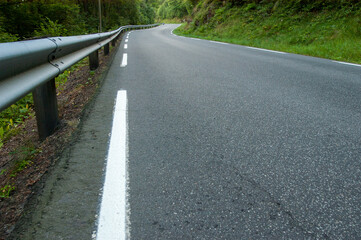 winding country road through forested hills.