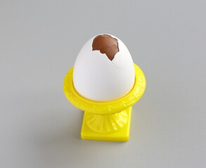 Chocolate egg with real eggshell in a yellow cup. Easter tradition in Finland.