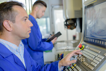 a male worker with machine screen