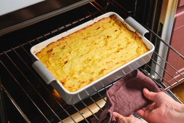 Removing a cooked Potato Casserole or Shepherd's Pie from the Oven. Recipes Potatoes. Thanksgiving...