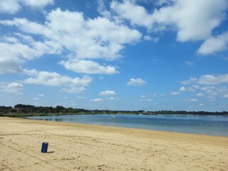 Sea view of the coast of the Netherlands (Rotterdam). Sea beach. Sea waves on sand beach. Panoramic view of Rotterdam beach long strip of white sand in the beginning of summer.