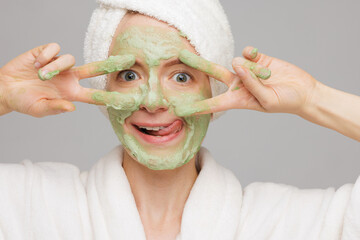 Playful Woman in Green Oxygen Cleansing Foam Face Mask Smiling, Fun Skincare and Beauty Treatment