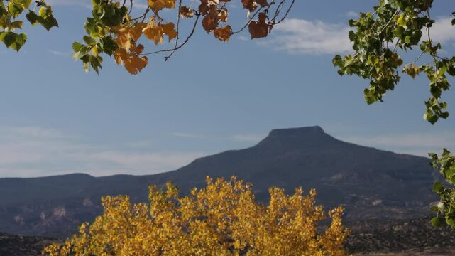 Cerro Pedernal, a distinctive northern New Mexico landmark, set off by dramatic autumn leaves