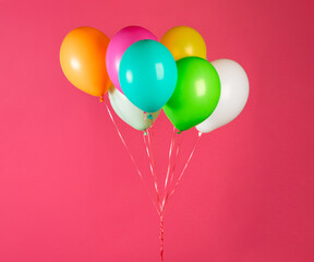 Children's party colorful balloons against pink background. Valentines day or birthday party concept.