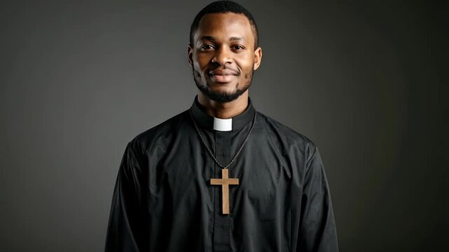 Portrait of a smiling African man in black clerical collar and cross necklace against a dark gray background