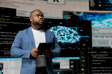 Black software expert focusing on programming language for innovation, reading binary code on...