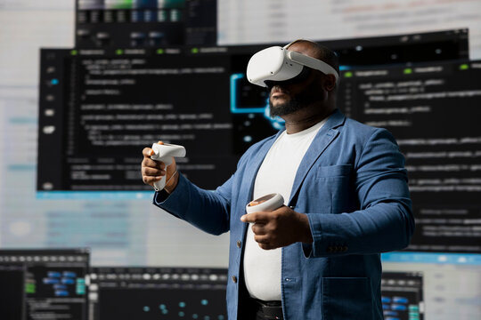 Black IT specialist engineer using VR headset and coding at innovation hub, showcasing the intersection of data science and cloud computing. Coding life with modern AI tools. - Powered by Adobe