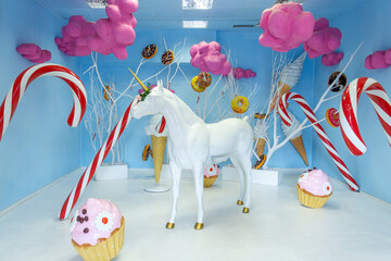 Candy-themed room featuring a unicorn and playful decor in bright pastel colors