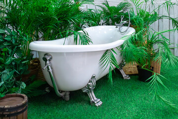 Relaxing vintage bathtub surrounded by lush greenery in a serene garden setting